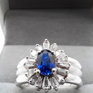 Sapphire diamond halo ring with vibrant blue center stone and sparkling diamond halo.